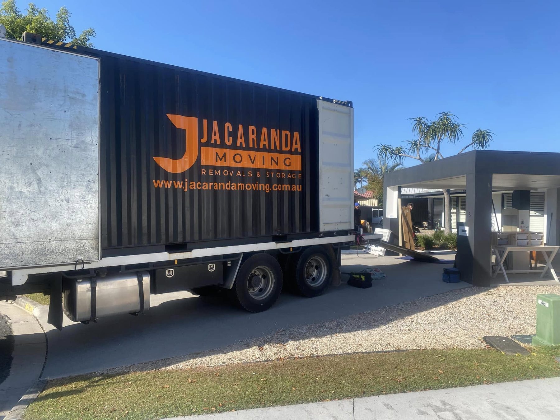 Jacaranda-branded shipping container being delivered to a Gold Coast home