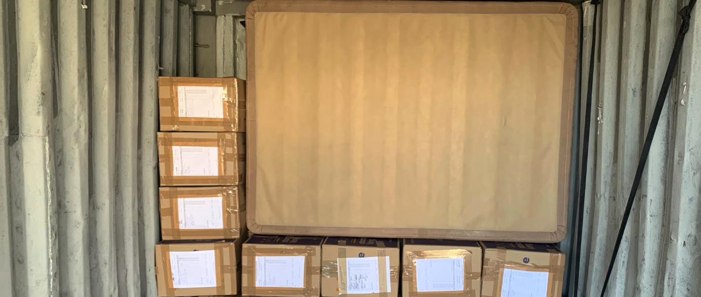 Packed estate cartons stacked in a storage container, each with its contents list facing outward