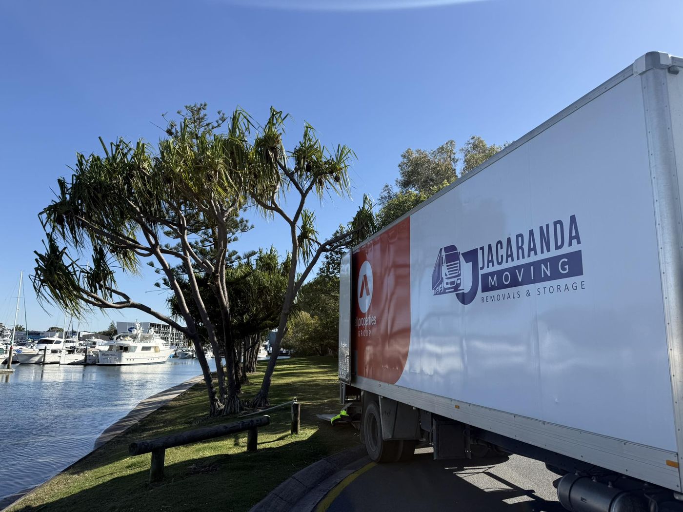 A branded Jacaranda truck on a waterfront Gold Coast removal